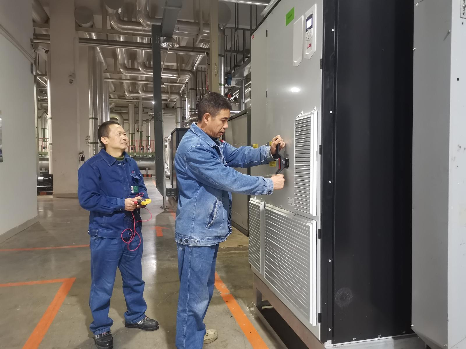 圖為技術(shù)人員正在測試改裝后的變頻器