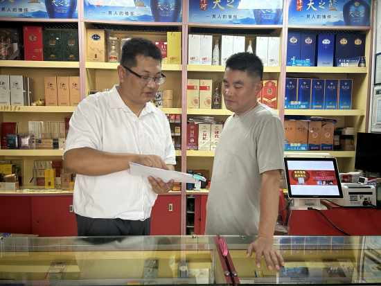 圖為客戶經理現(xiàn)場指導零售戶