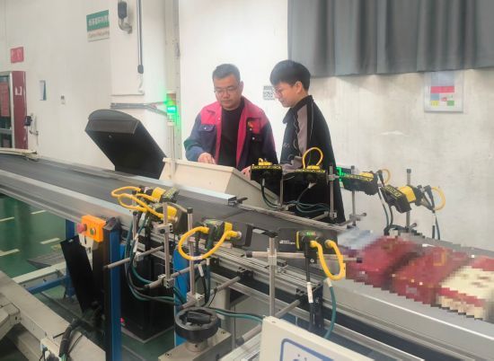 圖為老員工指導新進員工進行分揀操作